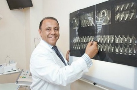 Dr. Sam Gilani, periodontist, reviewing diagnostic imaging