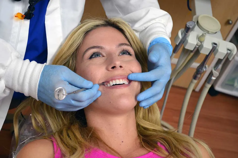 Patient receiving a periodontal examination in the dental chair